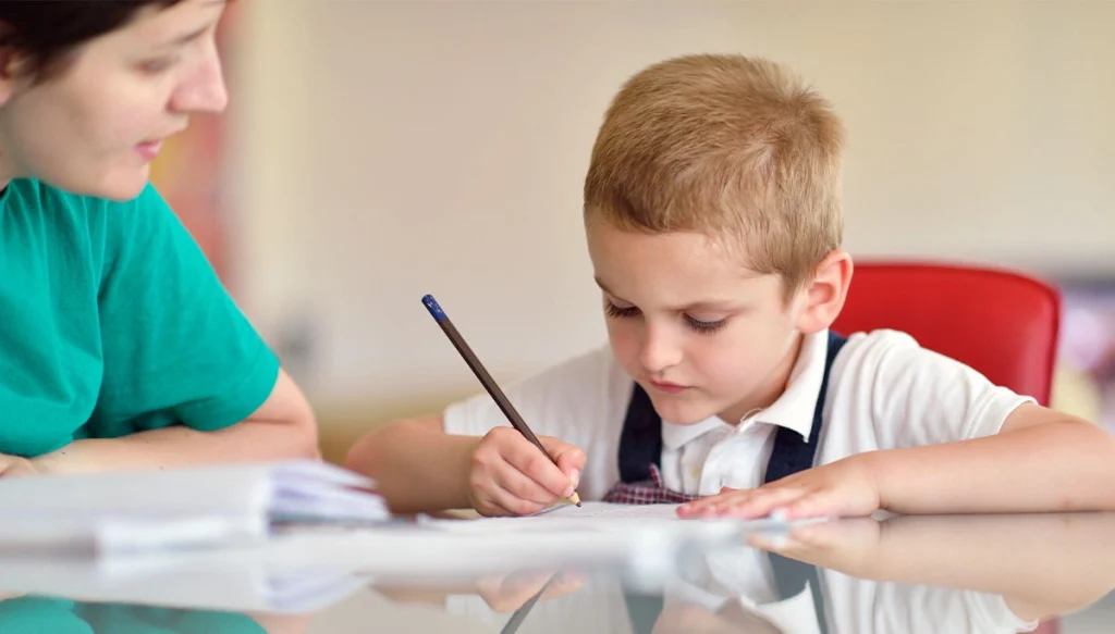 adult assisting child with home work